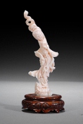 An angel-skin coral carving of beauty, with the original wood base.
