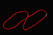 A STRAND OF RED CORAL NECKLACE