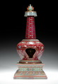A RARE RUBY-RED GROUND FAMILLE ROSE BUDDHIST STUPA