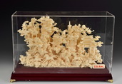 AN IVORY CARVED MOUNTAINOUS SCENERY WITH PAVILLIONS, PAGODAS, AND PINE GROVES