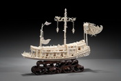 AN INTRICATELY CARVED IVORY DRAGON BOAT