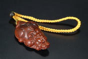 A WELL CARVED CINNABAR STONE PENDANT IN THE FORM OF PIXIU