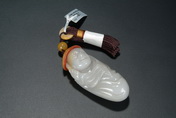 A CARVED JADE RIVER PEBBLE PENDANT