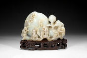A WHITE JADE CARVING OF MONKEYS AND PEACHES
