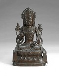 A Chinese carved bronze seated Guan Yin figure