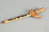 A jagged dagger with wooden sheath