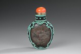 AN INSIDE PAINTED GLASS SNUFF BOTTLE ENCASED IN TURQUOISE