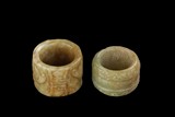 TWO CARVED JADE THUMB RINGS
