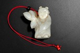 A WHITE JADE CARVED PENDANT OF A BOY