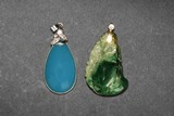 A CARVED JADEITE PENDANT AND A CHALCEDONY PENDANT