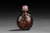 A CARVED GLASS SNUFF BOTTLE