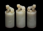 A GROUP OF THREE CARVED JADE 'LION' ROUND SEALS