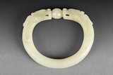 A CARVED JADE 'TWIN DRAGONS' BANGLE