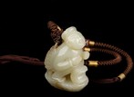 A CARVED JADE FIGURE ORNAMENT