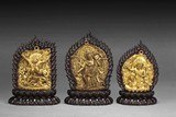 A SET OF THREE GILT BRONZE BUDDHA INSETS WITH ZITAN WOOD STANDS