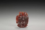 A CARVED AMBER FIGURE
