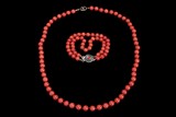 A RED CORAL BEAD NECKLACE AND TWO-STRAND BRACELET