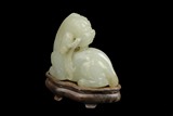 A WHITE JADE CARVING OF LION FIGURE