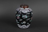 A FAMILLE ROSE BLACK GROUND JAR WITH COVER