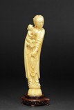 A CARVED IVORY 'LADY AND SON' FIGURE