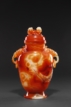 A CARVED RED AGATE TWO-HANDLED VASE
