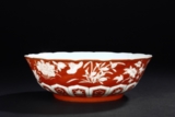 A REVERSE-DECORATED CORAL-GROUND BOWL