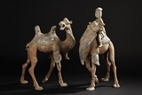 A SET OF TWO PAINTED POTTERY CAMEL AND FIGURES