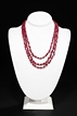 A THREE-STRAND RUBY NECKLACE WITH MOTHER PEARL FLOWER CLASP