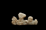 A WHITE AND RUSSET JADE CARVED BRUSH-REST
