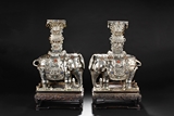 A PAIR OF SILVER MODELS OF ELEPHANTS INSET WITH GEMS