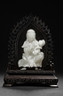 A WHITE JADE GUANYIN WITH LOTUS