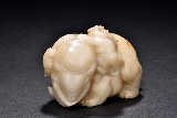 A WHITE AND RUSSET JADE CARVED ELEPHANT AND CHILD