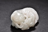 A WHITE JADE CARVING OF CATS