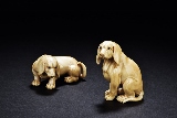 A PAIR OF TWO IVORY EUROPEAN DOGS