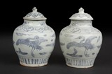 A PAIR OF BLUE AND WHITE'CRANES' SMALL JARS WITH COVERS