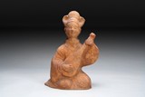 A CHINESE RED CLAY POTTERY FIGURE OF A LADY MUSICIAN