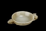 A WHITE JADE CARVED CUP WITH HANDLES