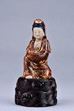 A GILT AND PAINTED MARBLE GUANYIN FIGURE