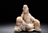 A SOAPSTONE CARVED GUANYIN FIGURE