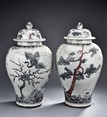 A PAIR OF BLUE AND WHITE JARS WITH COVER