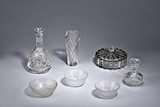A SET OF SEVEN GLASS CONTAINERS