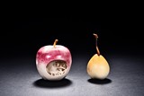 A SET OF TWO IVORY 'FRUIT' CARVINGS