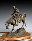 A CAST BRONZE COWBOY STATUE WITH THE TITLE 'THE RIDE FOR LIFE'