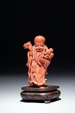 A CORAL CARVED FIGURE OF SHOULAO 