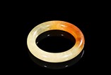 A YELLOW JADE CARVED BANGLE 