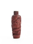 A CINNABAR LACQUER 'FIGUERS' SNUFF BOTTLE