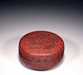 A CIRCULAR CINNABAR LACQUER CARVED BOX AND COVER
