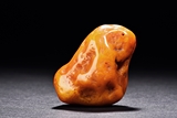 A NATURALISTIC CARVED AMBER