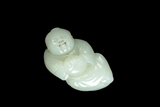 A WHITE JADE CARVED YOUNG CHILD FIGURE