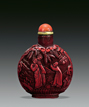 A CARVED CINNABAR LACQUER SNUFF BOTTLE WITH BOX